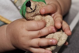 control hands with teddy bear