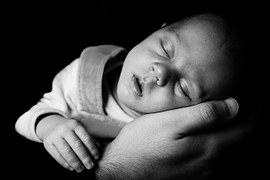 wonder baby asleep on hand